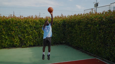 man playing basketball outside