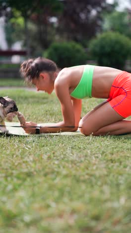 woman playing with a dog in a park