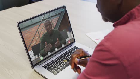 Video-of-african-american-man-having-video-call-on-laptop-with-afircan-american-male-coworker