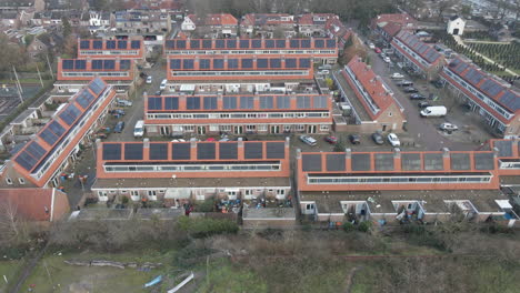 jib up of suburban neighborhood with solar panels on rooftops
