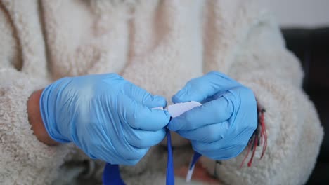 Close-up-of-medical-staff-unbuckling-a-snap-tourniquet-band