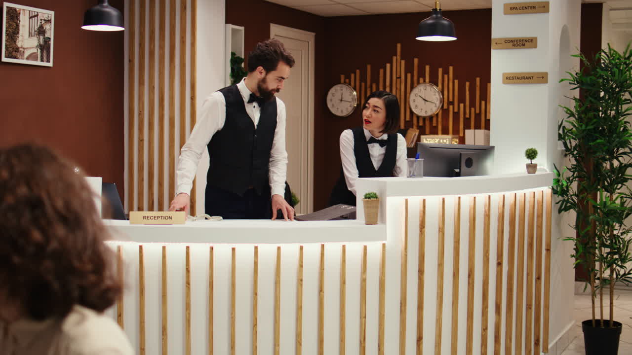 Hotel manager discussing room upgrade