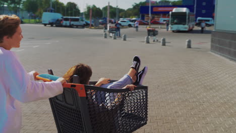 friends having fun in a shopping cart