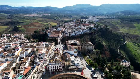 ronda spain cityscape, bridge, agriculture fields, and farmland river