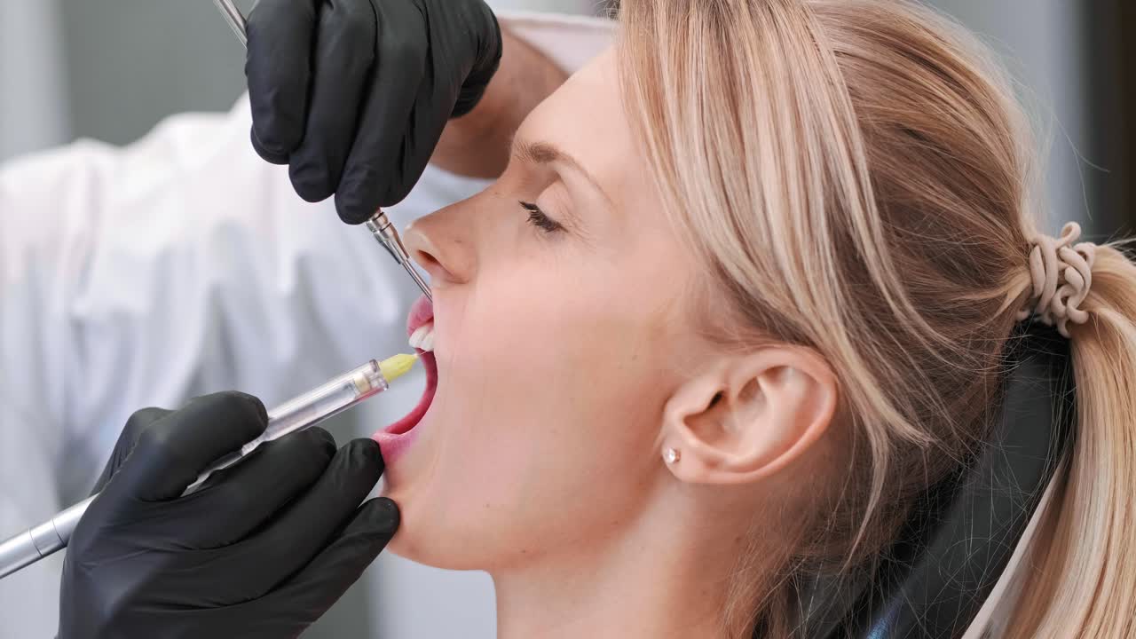 Part of dentist giving woman anesthesia in dentist's clinic