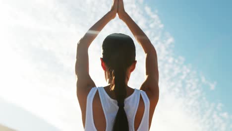 Rear-view-of-woman-performing-yoga