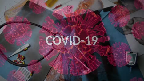 animation of macro covid-19 cells floating with word covid-19 over medical equipment