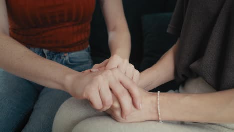 detail of stressed out woman consoled by a friend.