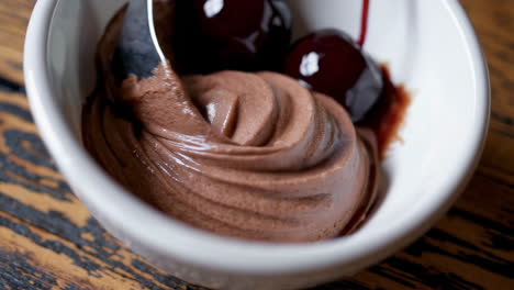 scooping chocolate ice cream with cherries
