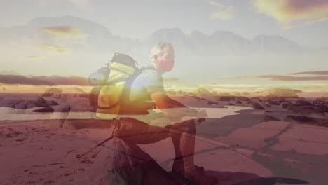 Caucasian-senior-man-wearing-face-mask-hiking-by-the-coast-over-fast-moving-clouds