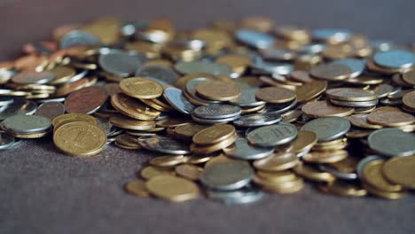 child plays with coins. large pile of money coins