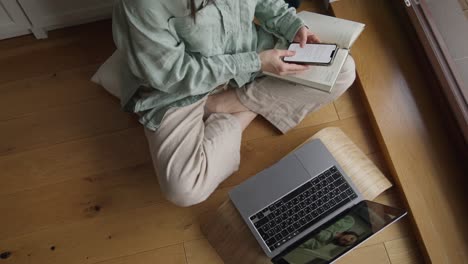 woman working from home with laptop and smartphone