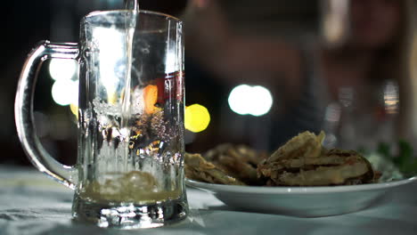 Pouring-beer-with-foam-into-glass-mug