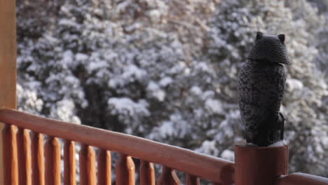 owl statue sits on deck of mountain cabin in zion national park