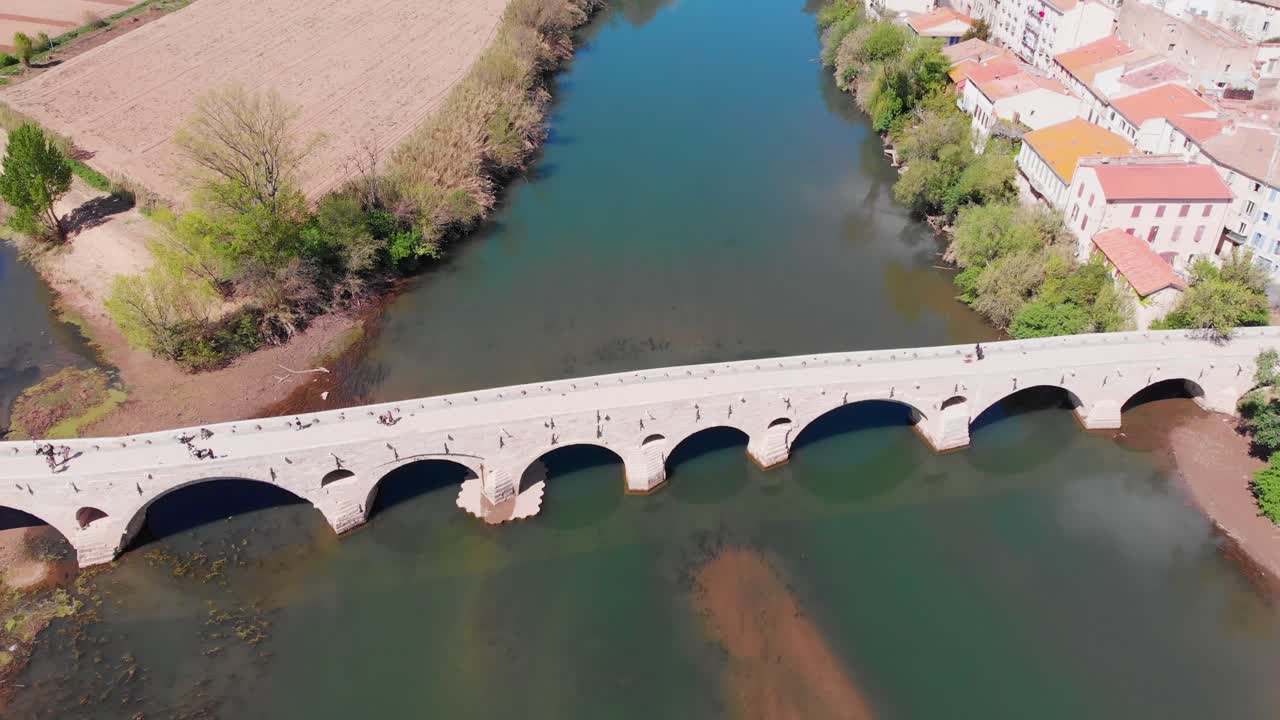 Aerial View of Historic Stone Bridge Over River with Town