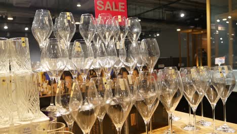 close up footage of wine glasses displaying on the shelf at mall