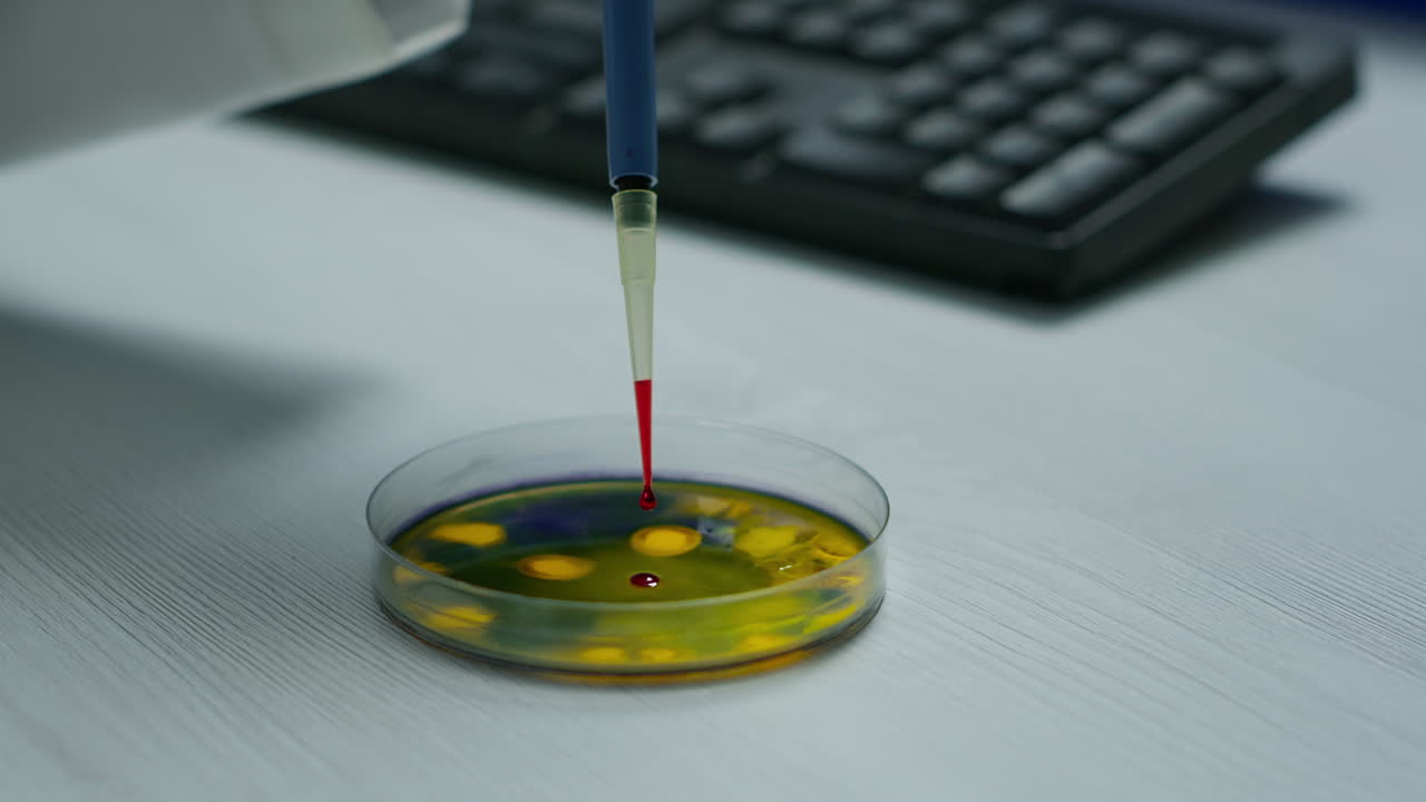 Close up of scientist using micropipette for analysing blood sample