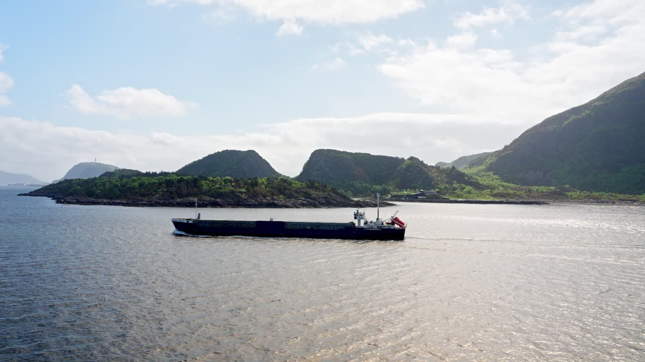 A cruise along the coast of Norway cargo ship is passing by on a voyage
