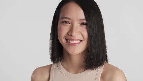 asian woman smiling to the camera.