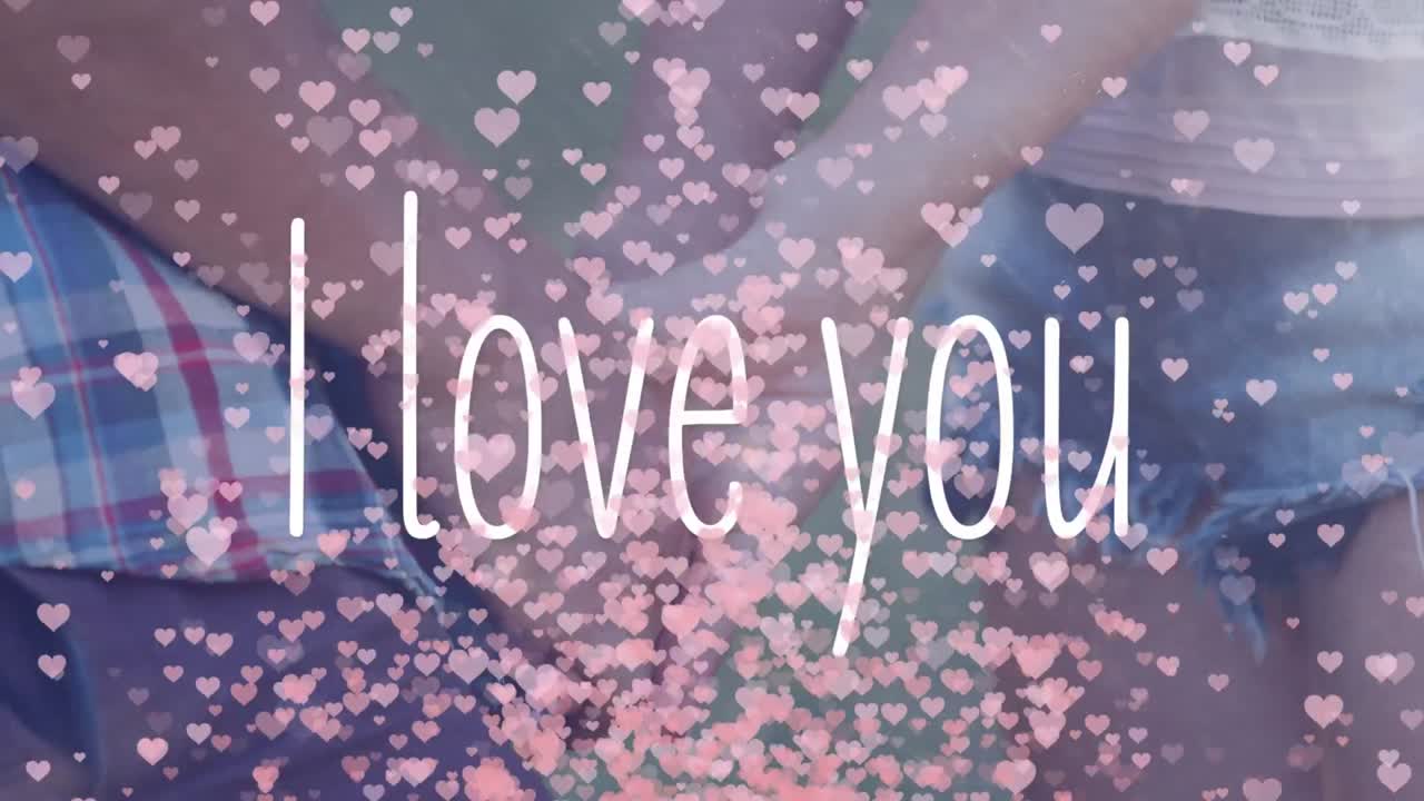 배경에서 손을 잡고 있는 사람들과 함께 "i love you"의 애니메이션