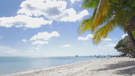 Tropical-resort-and-woman-sunbathing-with-tablet-computer