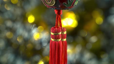 dreamy chinese new year symbol ornament, oriental decoration, traditional red hanging lantern ball, colorful and glowing depth of field, smooth close-up cinematic tilt up 4k video