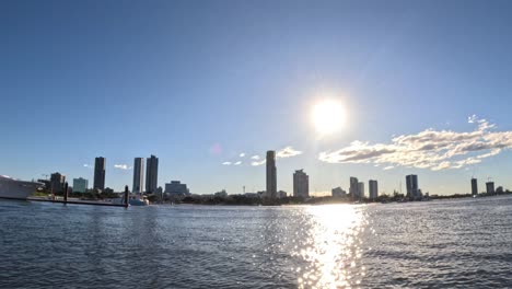 sun setting over gold coast cityscape and water