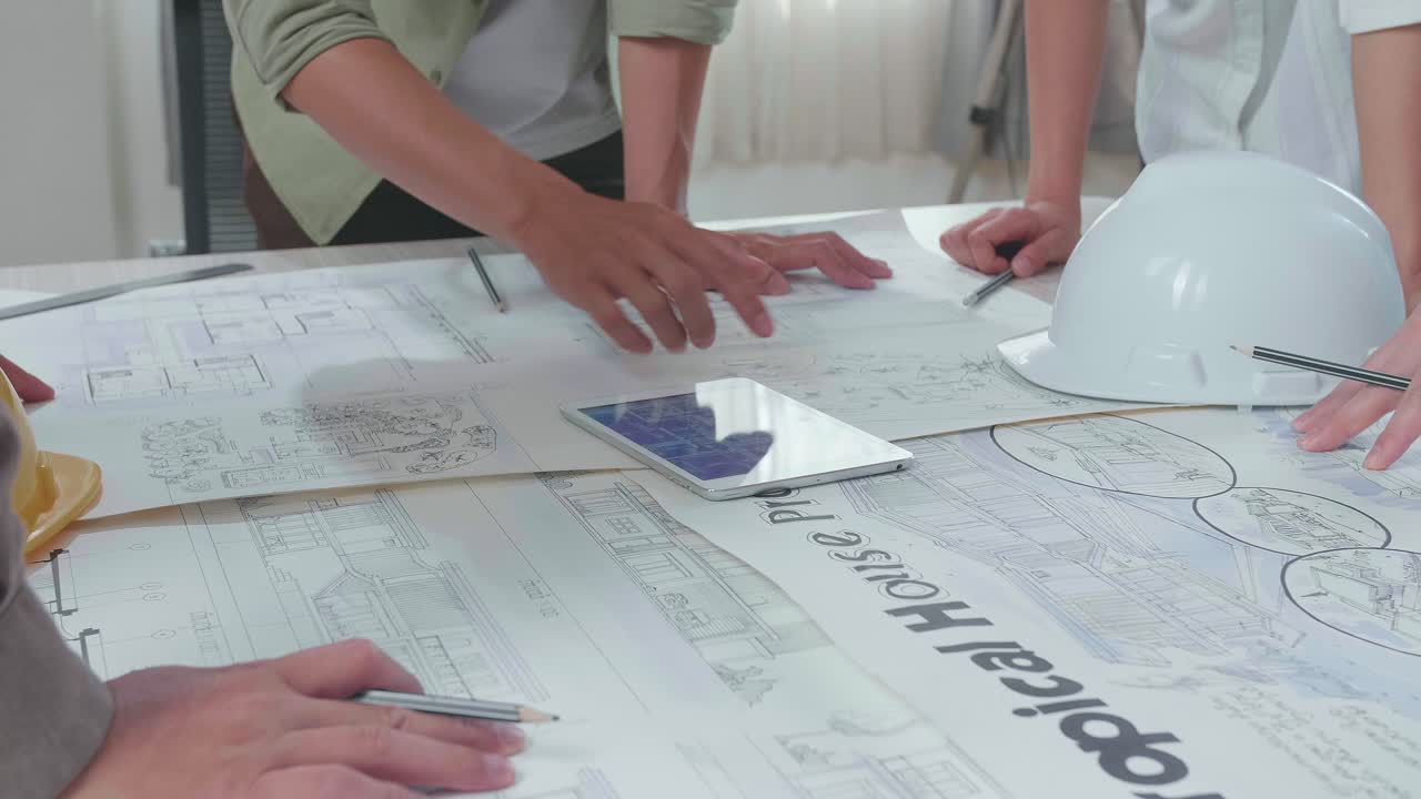 Close Up Of Group Of Asian Engineers Discuss About Work On The Tablet At The Office
