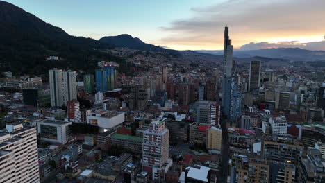 aerial view rising over buildings in downtown bogota, sunny evening in colombia