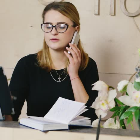 Young-administrator-speaks-on-the-phone-with-the-client-and-takes-orders-3