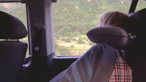 footage young woman sleeping while riding a bus. she laid an inflatable pillow under her head.