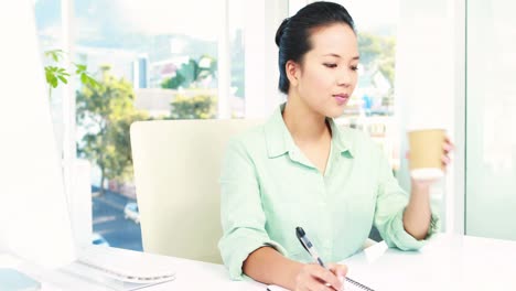 Asian-businesswoman-working-at-desk