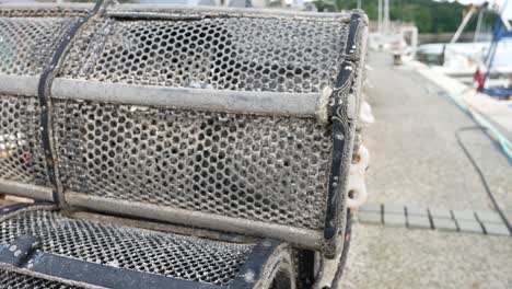 dolly right across fishery stacked lobster pots on coastal marine waterfront