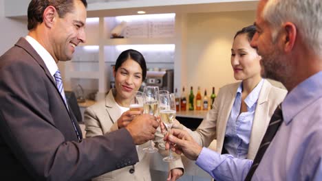 business associates celebrating after work and drinking wine