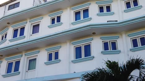 A-shot-of-the-facade-of-a-colonial-white-house-with-blue-windows