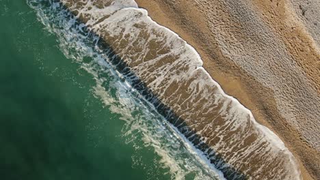 seascape. surf in the sand. aerial view with rotation in a circle.