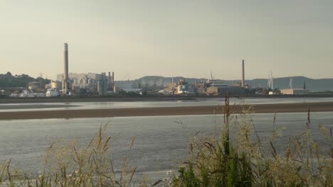 mirando a través del estuario del río mersey a runcorn industriales químicos frente al mar negocios de la fábrica al amanecer