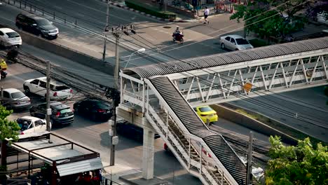 footbridge over road in bangkok, thailand with busy traffic