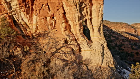 aerial perspective showcasing a majestic sandstone arch bathed in morning light near kanab.