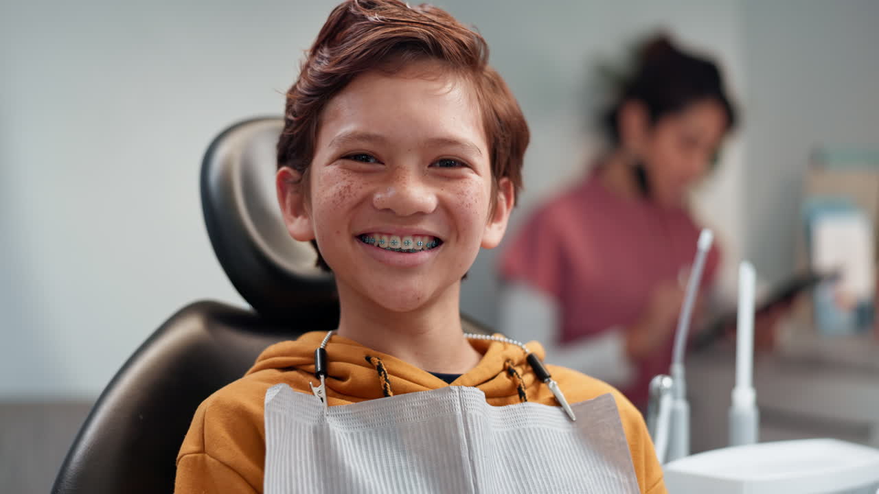 Happy Young Boy with Braces at the Dentist