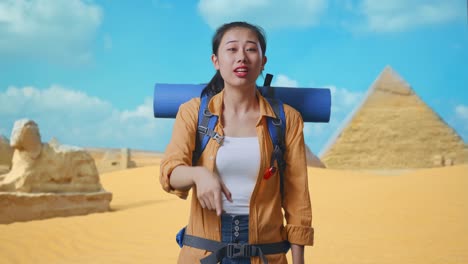 young woman traveler pointing in the egyptian desert