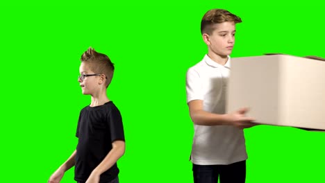 two boys pass boxes to each other on a green background