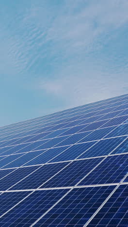 surface of blue photovoltaic solar panels mounted on building roof for producing clean ecological electricity. production of renewable energy concept. vertical video