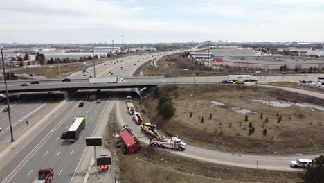 Aerial-orbit-overview-of-red-semi-truck-flipped-over-on-highway-on-ramp