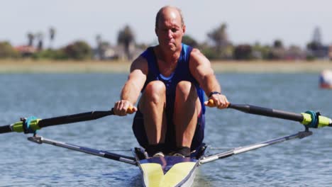 Senior-caucasian-man-rowing-boat-on-a-river