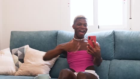 expressive person reacting to smartphone content on couch