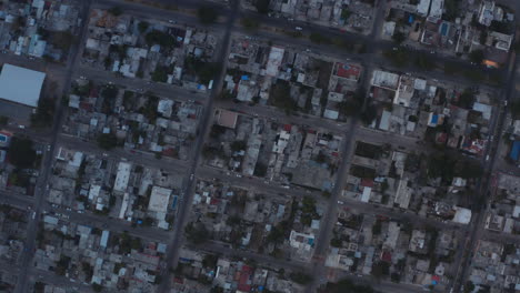 Aerial-spinning-shot-above-Playa-del-Carmen,-Mexico.-Amazing-view-with-the-rooftops-and-the-cars-traveling-on-the-streets