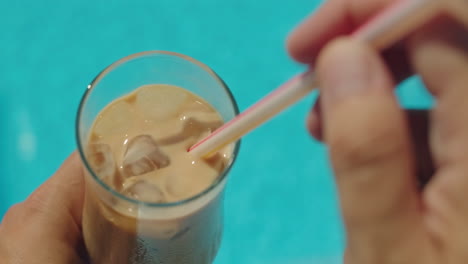 enjoying iced coffee by the pool