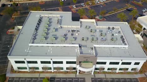 aerial side view of office buildings and rooftops with palm trees