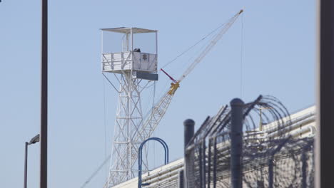high security facility with crane and watchtower